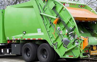 back of green refuse truck image